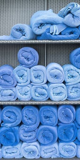 All blue towels rolled neatly