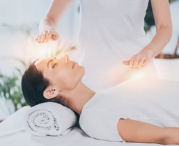 a woman is getting healed in a energy healing session