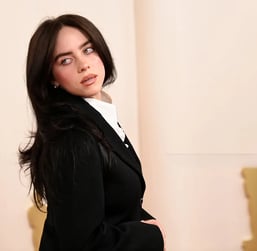 Billie Eilish in oversized Gucci attire at a 2025 Met Gala red carpet