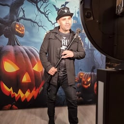 kahn posing in the halloween themed photo booth with his cane in Redlands.