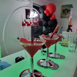 Drink tower in the background of a glow bar setup at halloween event Redlands.