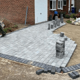 Driveway block paving in progress with concrete sub-base in Bristol