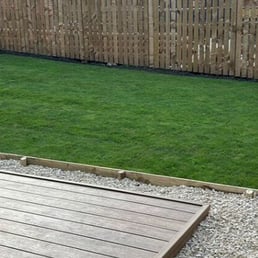 Freshly laid turf and garden edging with raised beds in Bristol