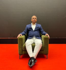 a man sitting in a chair with his feet on the floor