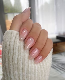 a woman's hand with neutral manicure nude manicure