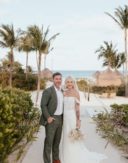 a bride and groom standing in front of a resort