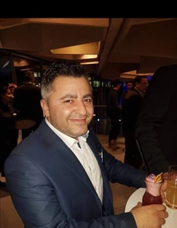 a man in a suit and tie smiling for a picture