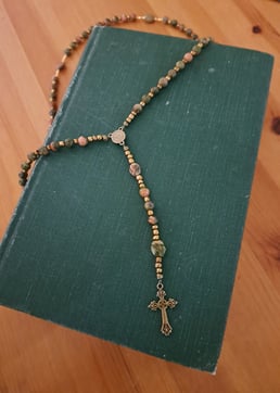 a rosary necklace with a rosary on it