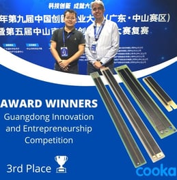 a man and woman standing in front of a blue and white banner