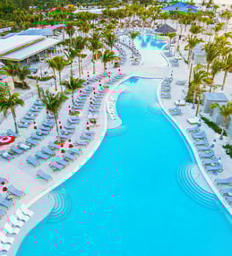 a large pool with lounge chairs and lounge chairs