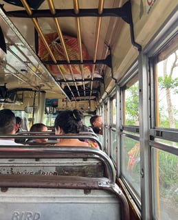 People sitting inside a local bus, known as a chicken bus, in Guatemala.