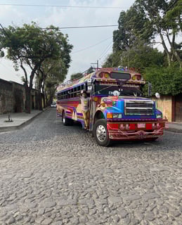 Traditional local bus, known as a chicken bus, in the streets of Antigua, Guatemala.