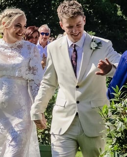 Couple At their Outdoor Wedding Ceremony Shaking Hands With Friends