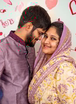 a man and woman in a purple outfit