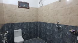 Bathroom at hotel rudra near jolly grant airport
