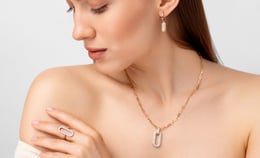a woman with a necklace and a necklace with a ring