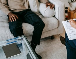 a man and woman sitting on a couch in a living room