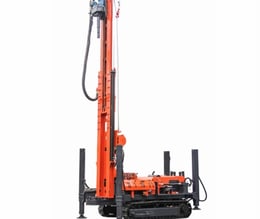 a drilling machine with a man standing in front of it