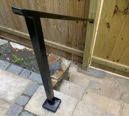 a metal pole with a black metal frame