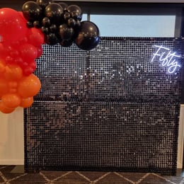 Black shimmer wall with a fifty neon for Shane's 50th in Wellington Point, Redlands.