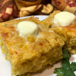 mexican cornbread topped with large pats of butter
