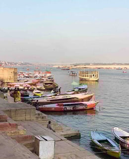 Photo of numerous colorful boats on the Ganges River in Varanasi, India.