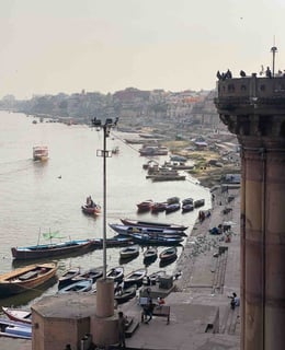 View of the ghats in Varanasi with various boats on the Ganges River
