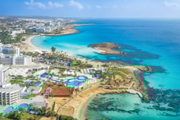 a large body of water with a beach and a resort