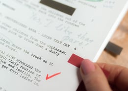 a person holding a piece of paper with a red arrow pointing to the left side