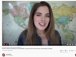 a woman with a smile on her face and a map of the world