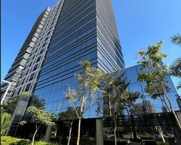 a tall building with a very tall building in the background