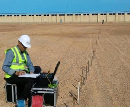 a man in a hard hat and a laptop computer