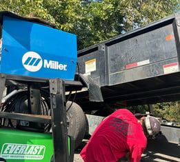 a man welding a heavy trailer