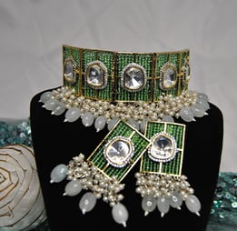 a bridal look necklace with a green beads and pearls