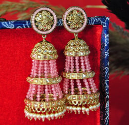 a pair of earrings with pink beads and gold accents