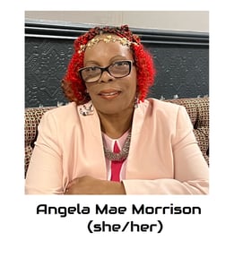 Angela is a black mid fat woman, her hair is red and she is wearing glasses.