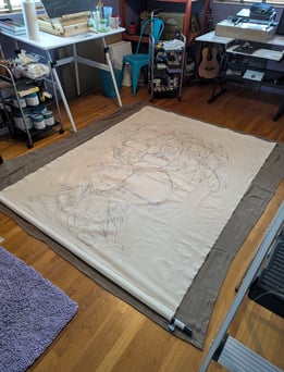 Linen tapestry laying on a clean surface on the floor for measuring and stretching.