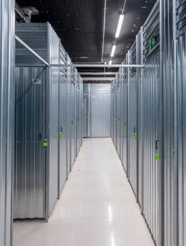 a long hallway with metal steel doors and a long hallway