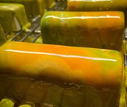 Multicolor glazed entremet with green and orange colours