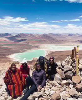 Photo de groupe en haut du sommet licancabur avec magnifique vue sur la Laguna Verde.