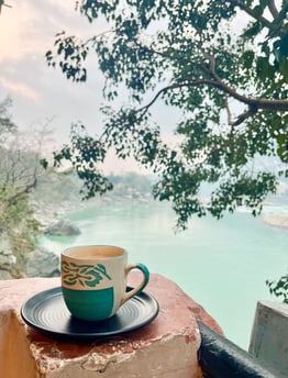 Taking a chai tea break by the Ganges river surrounded by nature in Rishikesh, India.