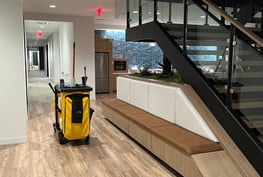 A janitorial cart inside a long hallway.