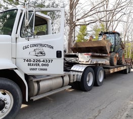 hauling backhoe to a job