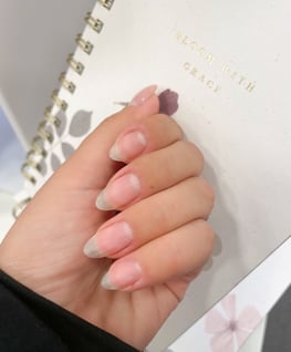 a person's hand without nail polish and Long almond shaped nails