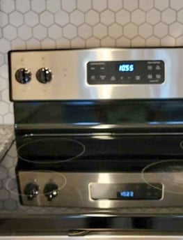a stove top oven with a clock on the stove