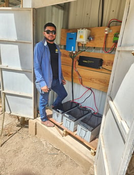 Yadir poses with a newly re-built battery system