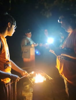 Youth cooking over an open fire