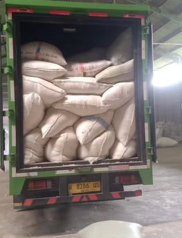 a truck with a large amount of bags of duck feather in the back of it