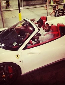 a man in a santa hat driving a white sports car