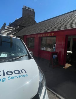exterior cleaning company van outside local bakery